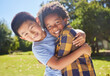 © N Lawrenson/peopleimages.com - Portrait, children and friends hugging in a park together for fun, bonding or playing in summer. Hug, kids and diversity with boy best friends embracing in a garden in the day during school holidays