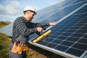 Wall Mural - Worker installing solar panels outdoors