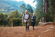 Holding hands, nature and senior couple hiking, walking and trekking in mountains of Peru. Travel, together and an elderly man and woman on a walk in a forest for exercise and retirement adventure