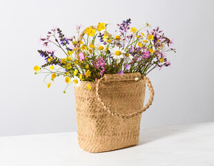 Wall Mural - Straw bag with wildflowers