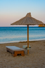 Canvas Print - Sunset view of parasols and sunbeds at Vai beach at Crete, Greece