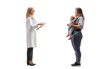 Poster - Full length profile shot of a female doctor talking to a mother with a baby