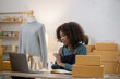© SOMKID - Young African American woman and online selling at home office, Startup small business owner working Online selling and product order for delivery to customer.