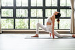 © mojo_cp - Fitness woman doing yoga exercise stretching on mat yoga, wellbeing lifestyle.