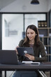 © SOMKID - Happy excited young successful business woman and working online at the table in office,