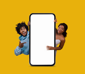 Wall Mural - Excited Young Black Man And Woman Pointing At Big Blank Smartphone