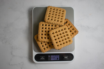 Wall Mural - Cookies, kitchen scales on a light background