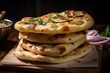© Irfanan - freshly baked nan and garlic bread on a tray with perfect doneness
