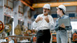 © Montri - Portrait of female engineer team standing and working in industrial factory. Professional engineering, worker, woman Quality control. Male and female industrial engineers using tablet computer.