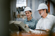 © Montri - Portrait of female engineer team standing and working in industrial factory. Professional engineering, worker, woman Quality control. Male and female industrial engineers using tablet computer.
