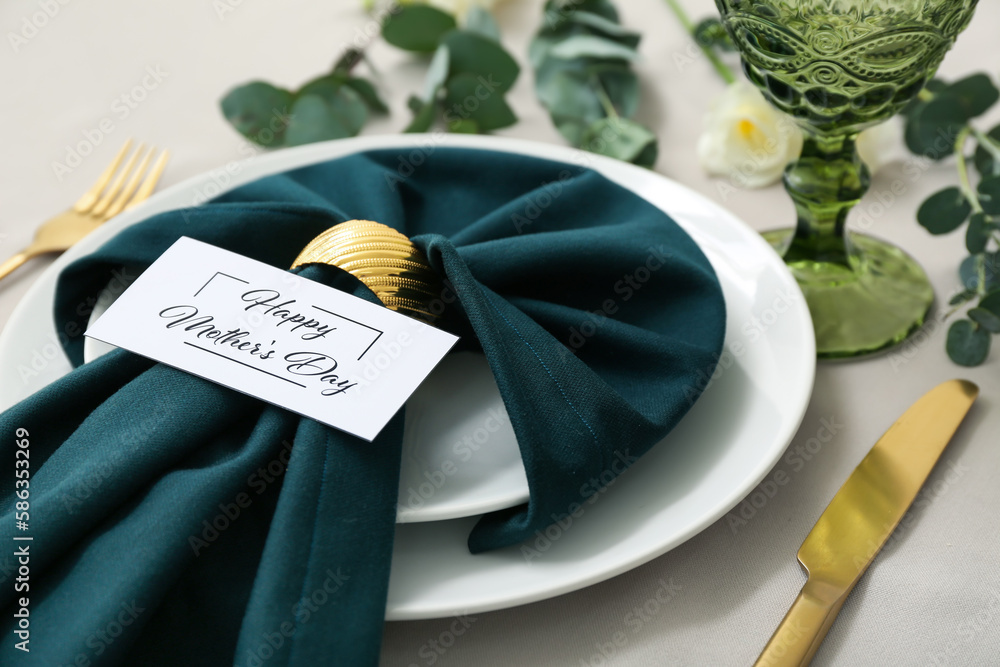 Setting for Mother's Day celebration with eustoma flowers and eucalyptus branches on table, closeup