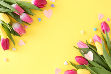 Wall Mural - Mother's Day celebration idea. Creative layout made of origami paper hearts bouquets of flowers colorful tulips and hearts baubles on isolated light yellow background. Flat lay with copyspace