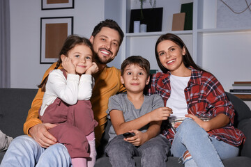 Poster - Happy family watching TV at home in evening