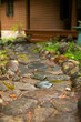 Stone pathway leading to wood cabin front porch.
