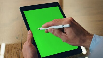 Artist hand drawing stylus on chromakey tab display closeup. Designer using pen