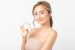 © Shutter B - Happy beautiful young asian woman holding cosmetic cream blank bottle, Fashion model, Health wellness, Beautiful girl skin care and facial treatment. Isolated on white background.