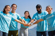 © Verin - group of diverse ethnicity volunteers stack their hands on top of each other's with their palms face-down gesture of engage in some sort of teamwork activity, join forces together to work for society