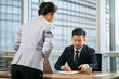 © imtmphoto - asian business manager reviewing report in office