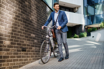 Happy middle age caucasian stylish businessman going to work by bike.