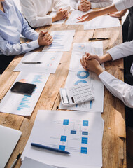 Financial analysts analyze business financial reports on a digital tablet planning investment project during a discussion at a meeting of corporate showing the results of their successful teamwork.