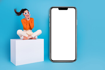 Sticker - Photo of positive emotion impressed woman in 3d glasses excited to see phone promo placard isolated on blue color background