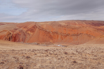 Image with beautiful natural tourist landscape with high red mountains under blue summer sky.Fabulous view concept.