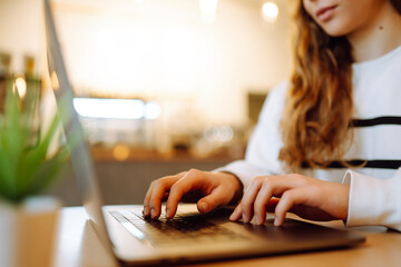 Wall Mural - Female hands working on a laptop, close-up. Business, technology, internet and networking concept.