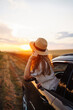 © maxbelchenko - Relaxed happy woman on summer road trip travel vacation leaning out car window. Lifestyle, travel, tourism, nature, active life.