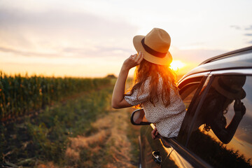 Wall Mural - Relaxed happy woman on summer road trip travel vacation leaning out car window. Lifestyle, travel, tourism, nature, active life.