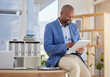 © Yusrah Abbas/peopleimages.com - Business, tablet and search with black man in office for digital, communication and email. Internet, technology and corporate with male employee in agency for planning, browsing online and networking