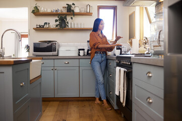 Poster - Kitchen, thinking and woman prepare coffee for breakfast latte, cappuccino and hot beverage at home. Relaxation, calm morning and thoughtful girl make espresso, caffeine drink and brewing for peace