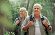 © Nina/peopleimages.com - Hiking, elderly couple and active seniors in a forest, happy and relax while walking in nature. Senior, backpacker and woman with man outdoors for travel, freedom and healthy lifestyle in retirement