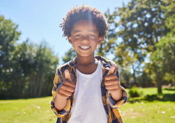 Canvas Print - Happy child, portrait or boy with thumbs up in park for a fun activity or playing in nature or summer. Excited young African kid smiling on holiday outside with success, happiness or achievement