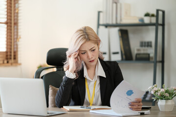 Close up on laptop in office, Asian happy beautiful businesswoman in formal suit work in workplace. Attractive female employee office worker smile.