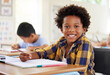 © Nina/peopleimages.com - Education, drawing portrait or boy child in classroom learning, exam or studying with preschool notebooks. Development or kids or happy student with creative art writing for knowledge in kindergarten