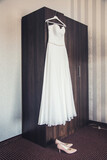 Fototapeta  - Suknia ślubna wisząca na szafie