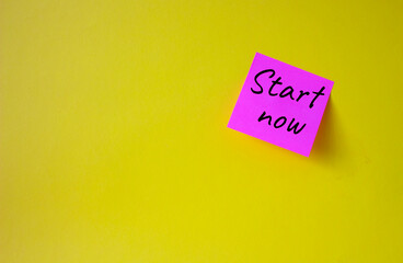 Wall Mural - Start now symbol. Pink steaky note with words Start now. Beautiful yellow background. Business and Start now concept. Copy space.