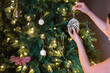 © Austockphoto - young teen hanging pretty ornament on xmas tree