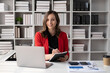 © Parichat - Young beautiful businesswoman working and holding notebook in her hand, ready to write some ideas.