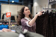 © _KUBE_ - Black friday. Pretty young caucasian woman consultant working in clothing store. Concept of shopping and sales