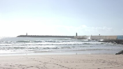 Wall Mural - Landscape of the sea beach - lighthouses in the distance on rocky tetrapods