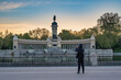 © Noppasinw - Madrid Spain, sunrise city skyline at El Retiro Park with woman tourist