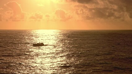 Wall Mural - Nature landscape - a sea vessel sails the sea at sunset