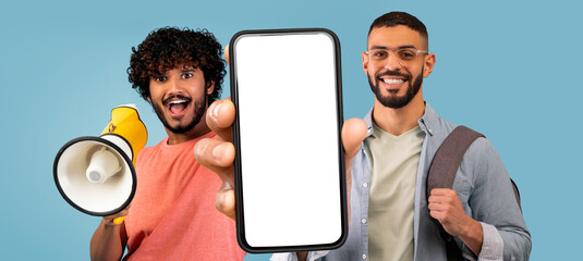 Wall Mural - Mobile Offer. Two Multiethnic Guys Using Megaphone And Showing Big Blank Smartphone