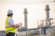 © reewungjunerr - Asian man petrochemical engineer working at oil and gas refinery plant industry factory,The people worker man engineer work control at power plant energy industry manufacturing