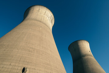 Nuclear power plant and cooling towers. View of  nuclear power plant with cooling towers. Abandoned cooling tower in power plant. 