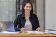 © David - Portrait of business asian woman working on laptop in her workplace. asian smile business lady employee working on laptop in office finance business concept.