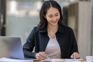 Portrait of business asian woman working on laptop in her workplace. asian smile business lady employee working on laptop in office finance business concept.