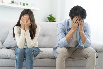 Wall Mural - Family problems, Asian women cover her face and sit separately from husband feel disappointed after quarrels at home.