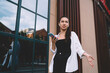 © BullRun - Woman in earbuds having phone call outdoors